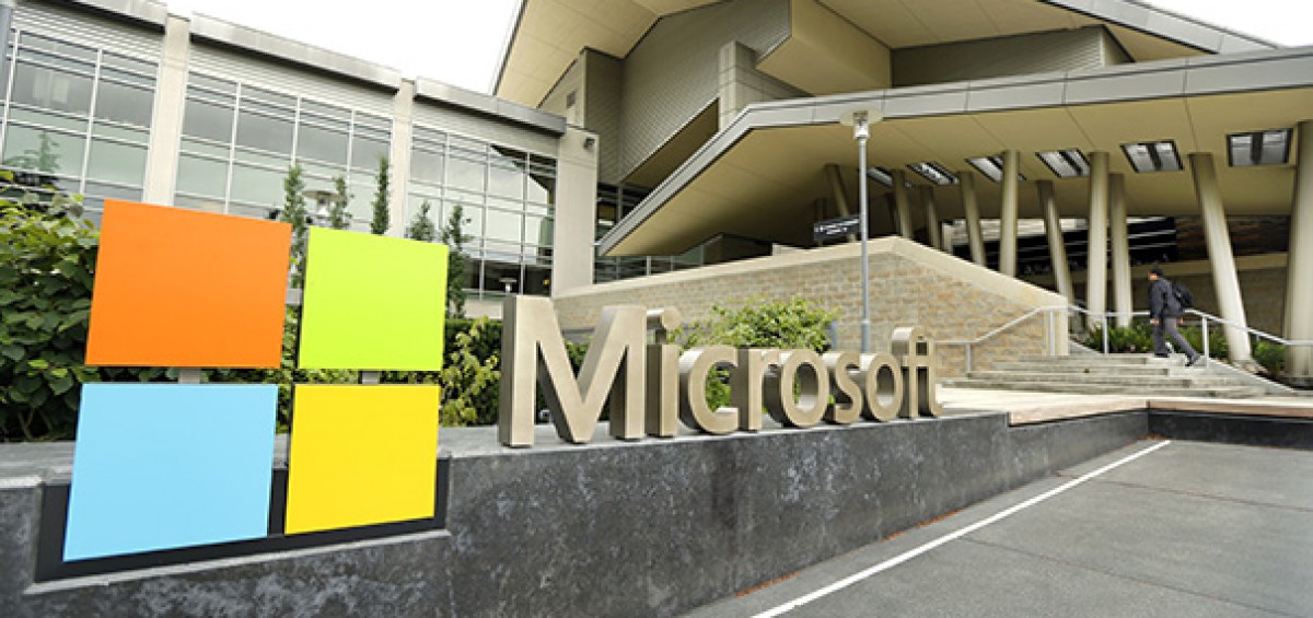 This July 3, 2014 photo shows Microsoft Corp. signage outside the Microsoft Visitor Center in Redmond, Wash. Microsoft on Thursday, July 17, 2014 announced it will lay off up to 18,000 workers over the next year. (AP Photo Ted S. Warren)